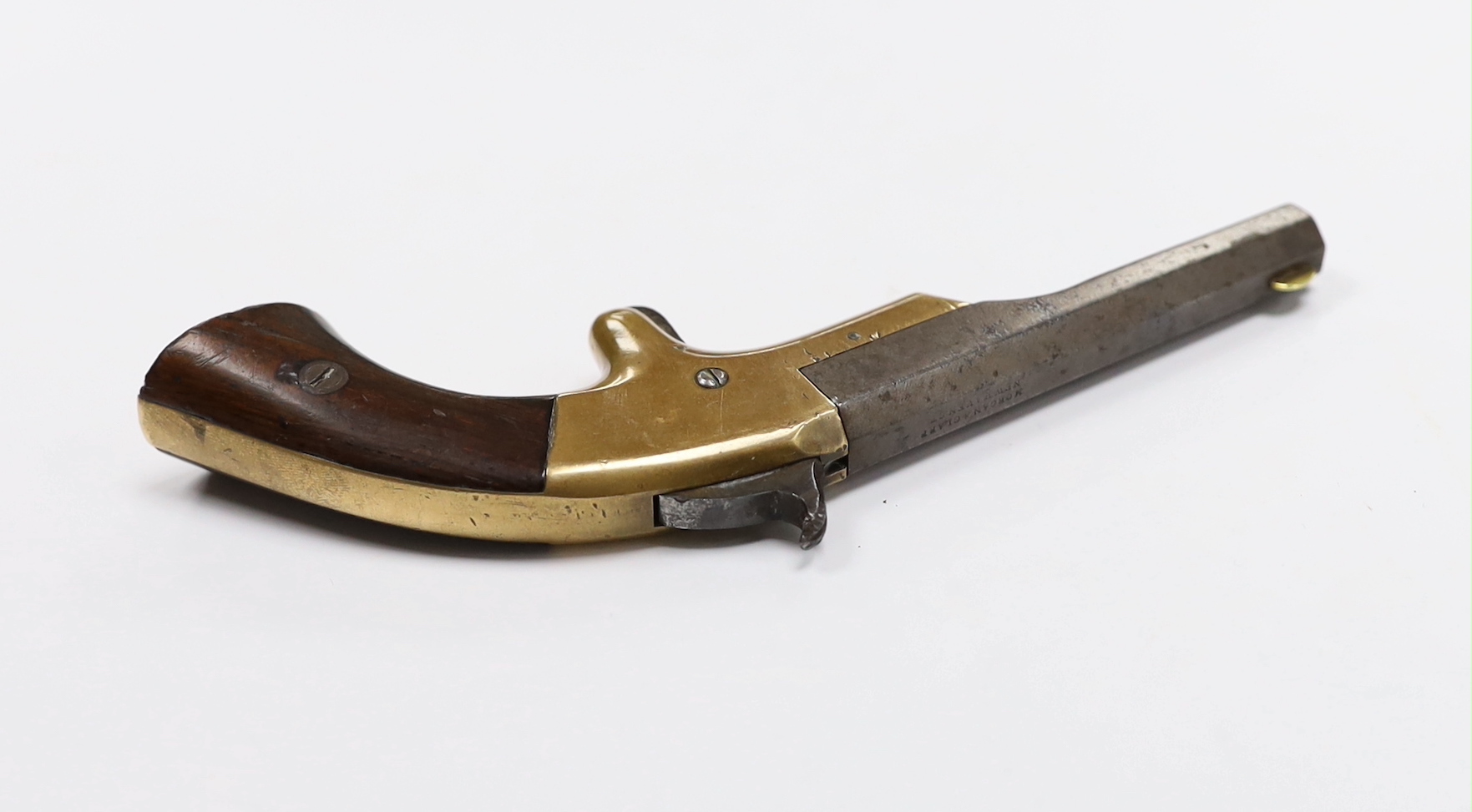 A 19th century miniature percussion pistol with brass lock and octagonal barrel, stamped Morgan and Clapp Newhaven CT, barrel 9cm